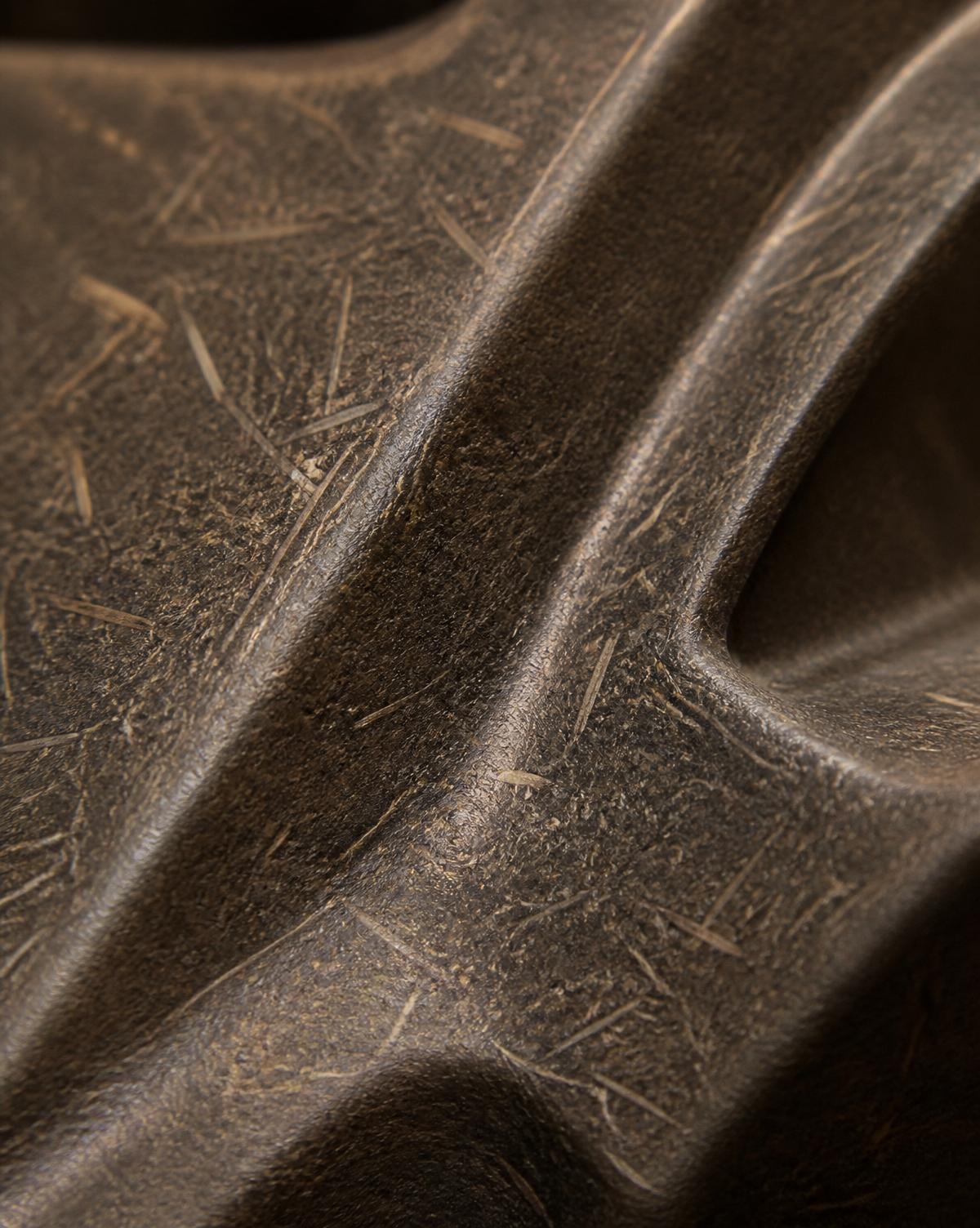Detail of a natural-fiber composite panel used in vehicle interiors.